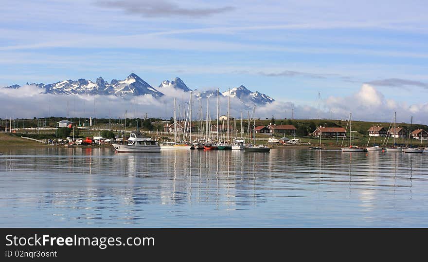 Yachts stays in calm gulf near mountain vilage. Yachts stays in calm gulf near mountain vilage