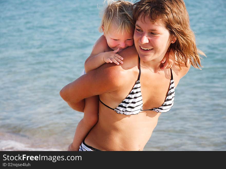 Happy mother and kid on sea