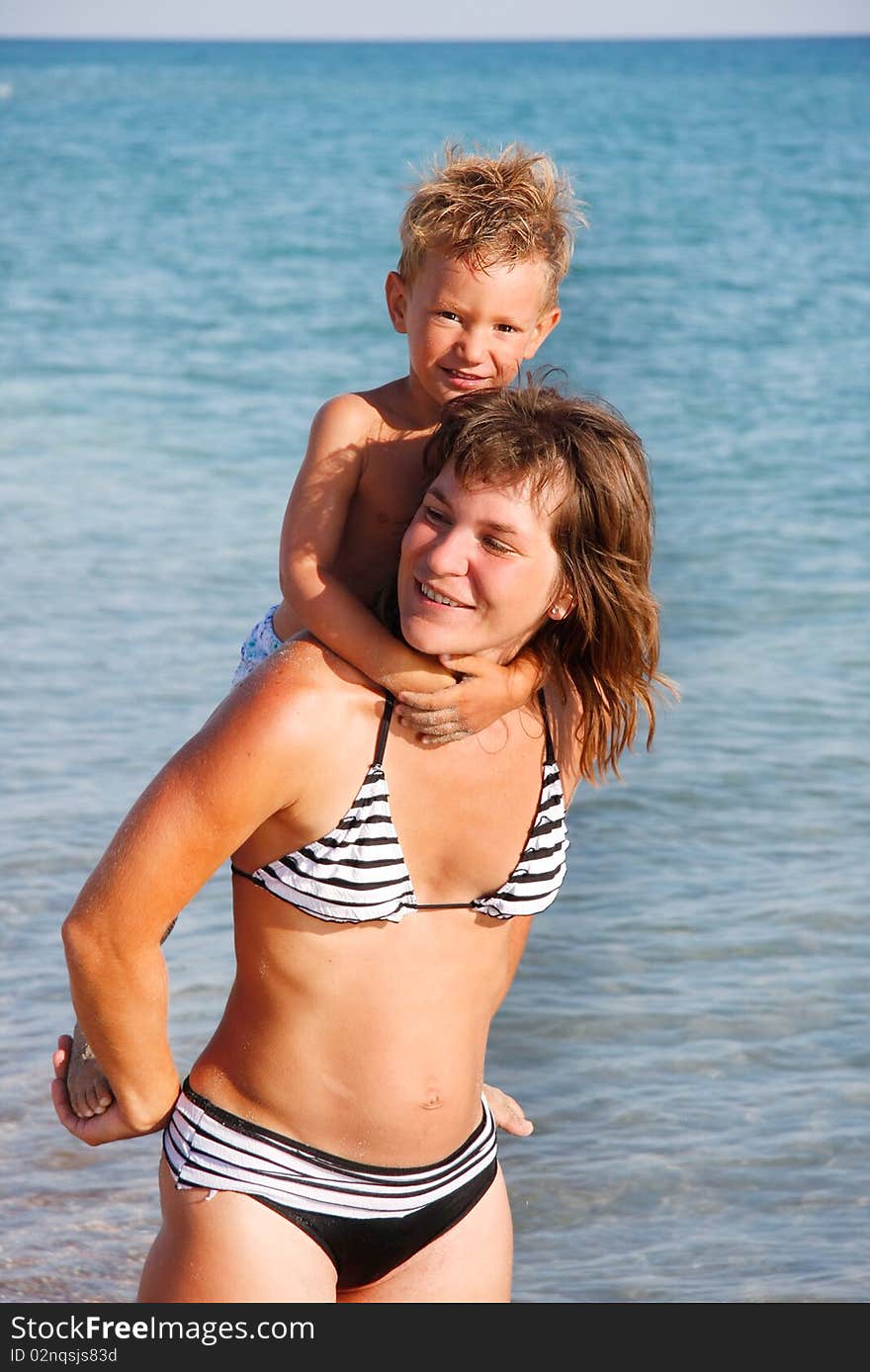 Happy mother and son on sea background