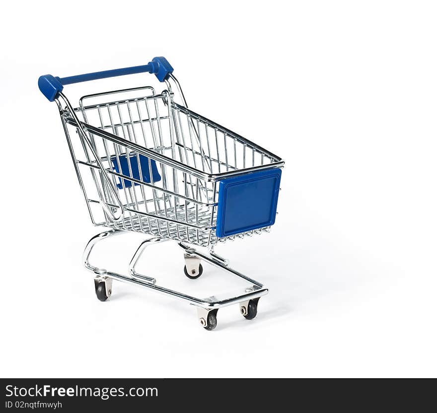 Isolated shopping trolley on yellow