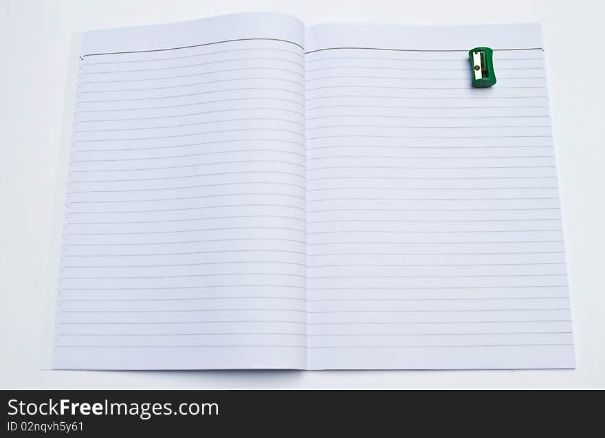 Opening book and pencil Sharpener on white background.