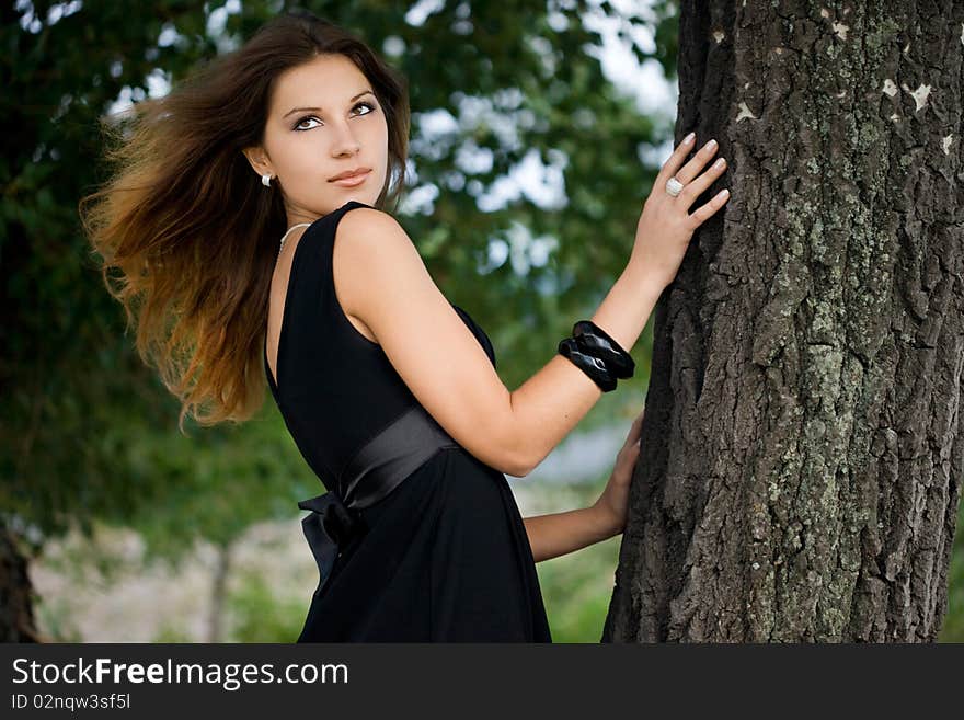 Beautiful woman near the tree