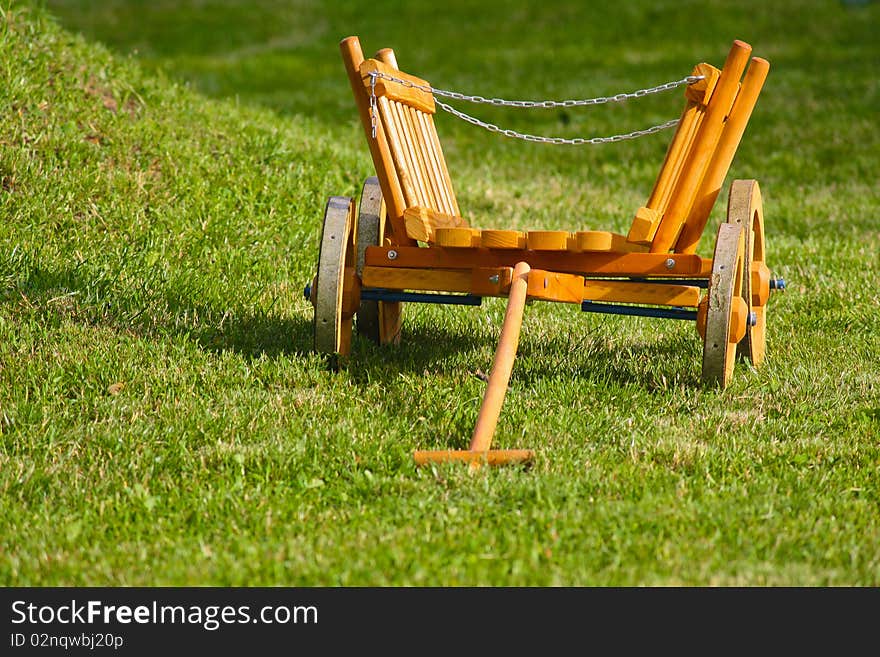 Wooden toy cart in the grass