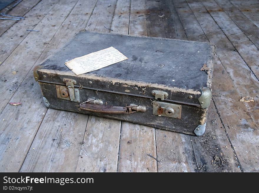 Ancient suitcase on board to a floor.