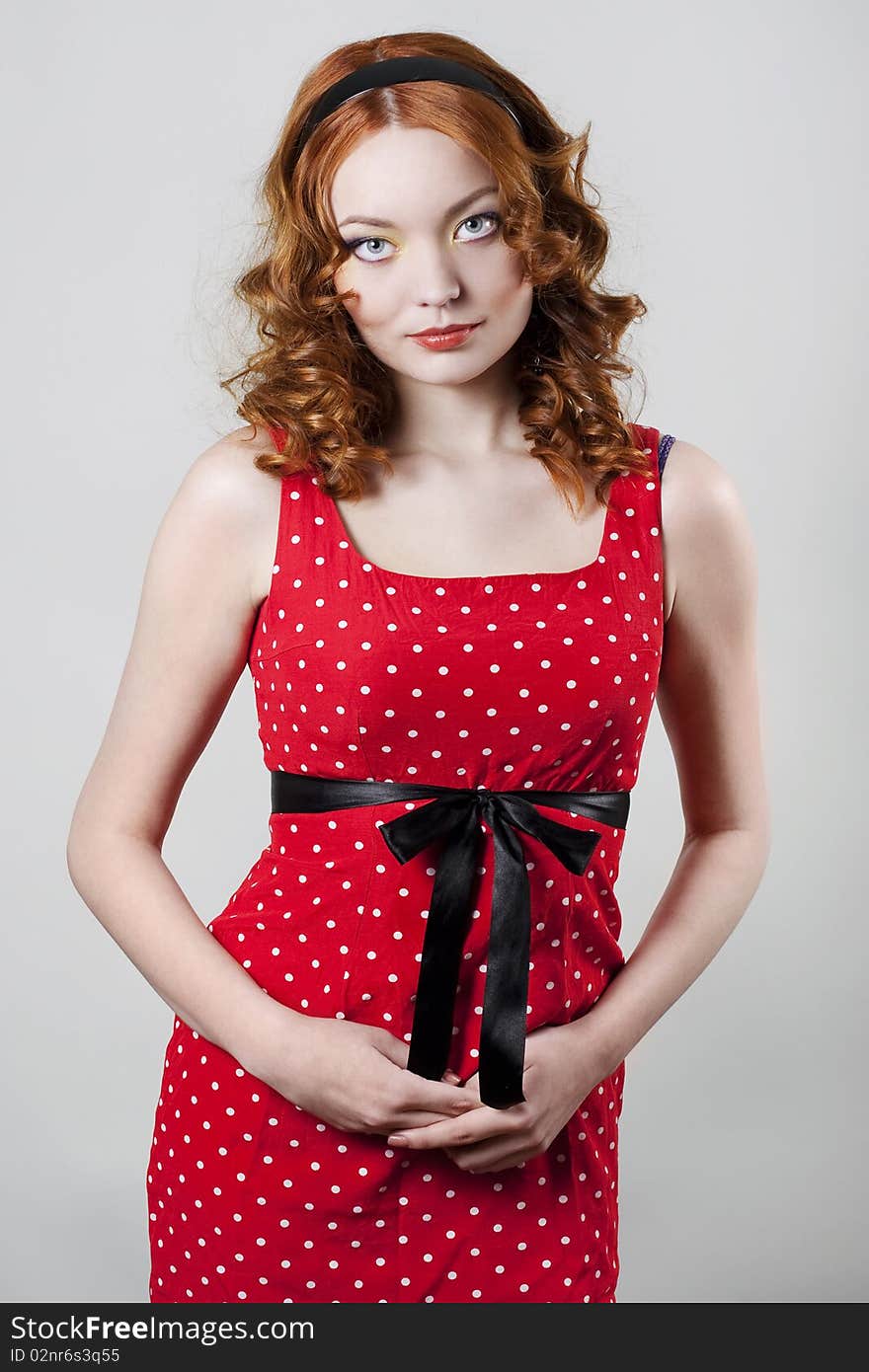 Pin-up portrait of woman looking over left shoulder wearing red dress. Pin-up portrait of woman looking over left shoulder wearing red dress