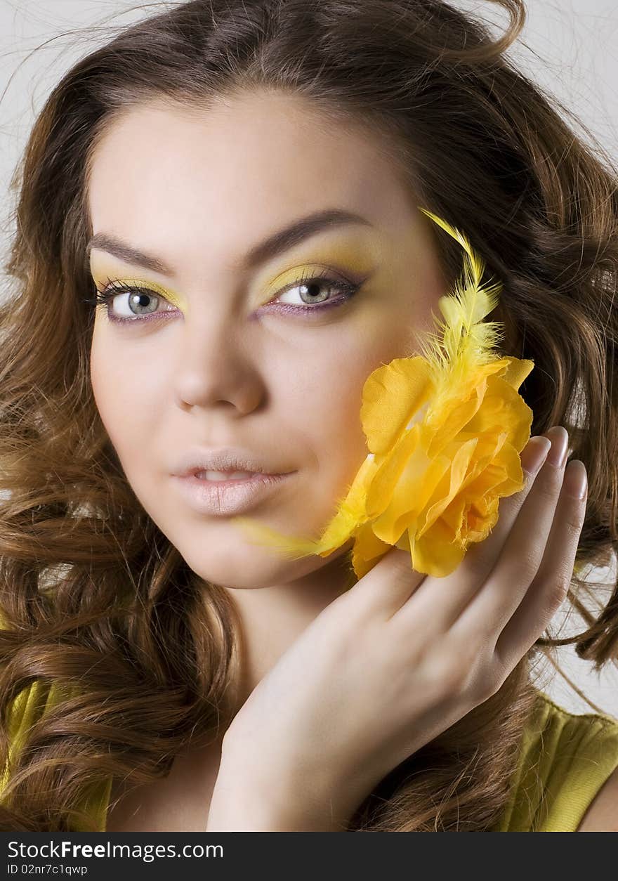 Fashion model posing with rose in her hands. Fashion model posing with rose in her hands.