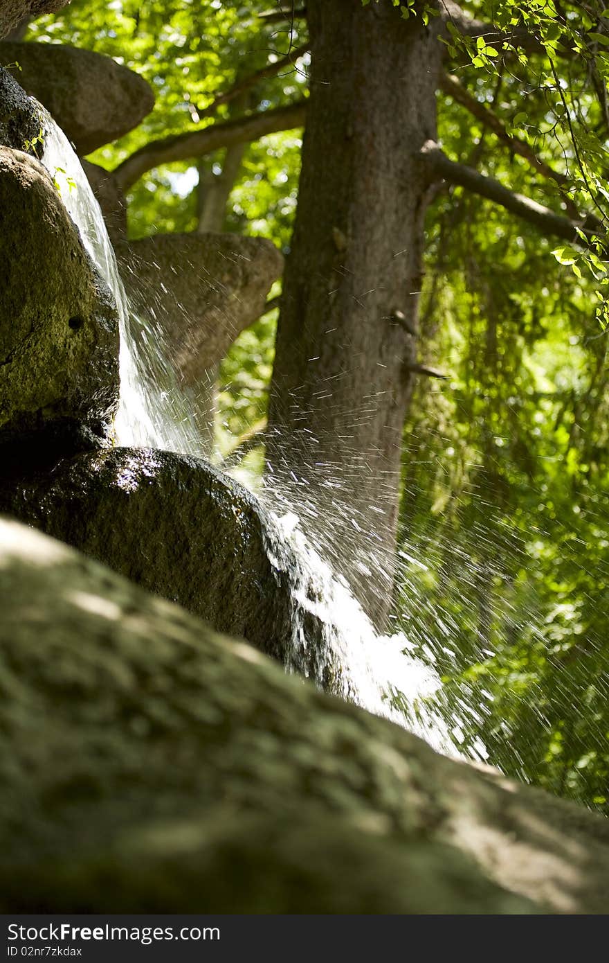 Close up view of the little waterfall in the forest