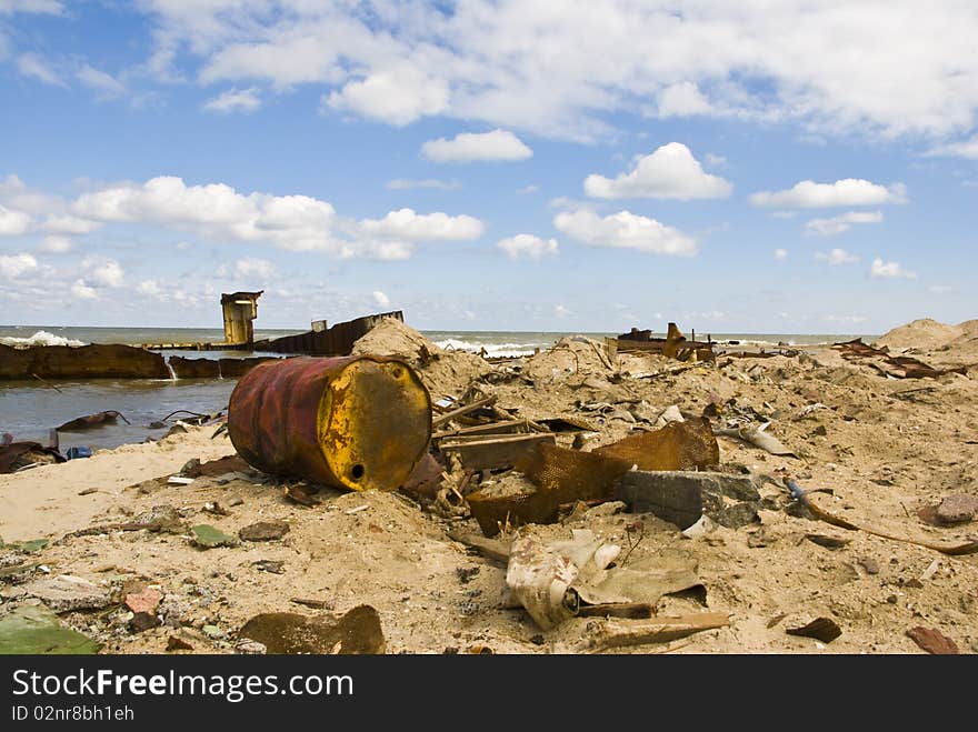 Fragments of old ships and metal debris washed up on shore. Fragments of old ships and metal debris washed up on shore