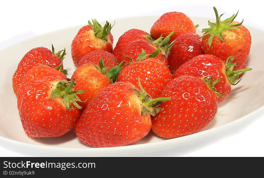 A close up shot of strawberries on a plate. A close up shot of strawberries on a plate.