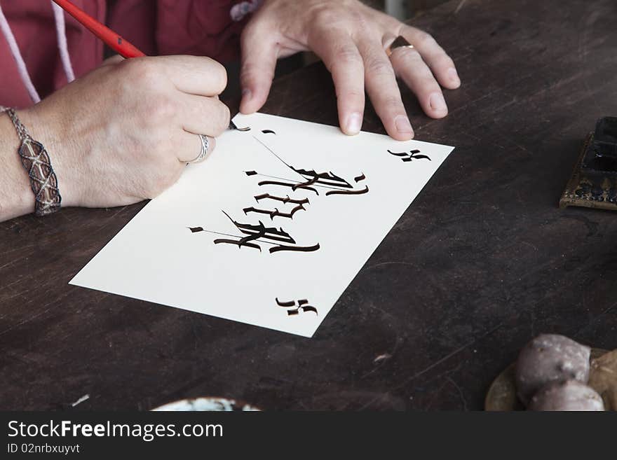 Calligrapher's hands making a gothic-letter ink pen crafts and old-fashioned. Calligrapher's hands making a gothic-letter ink pen crafts and old-fashioned