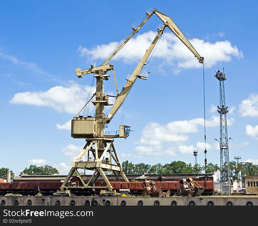 Crane unloading coal from cargo train. Crane unloading coal from cargo train