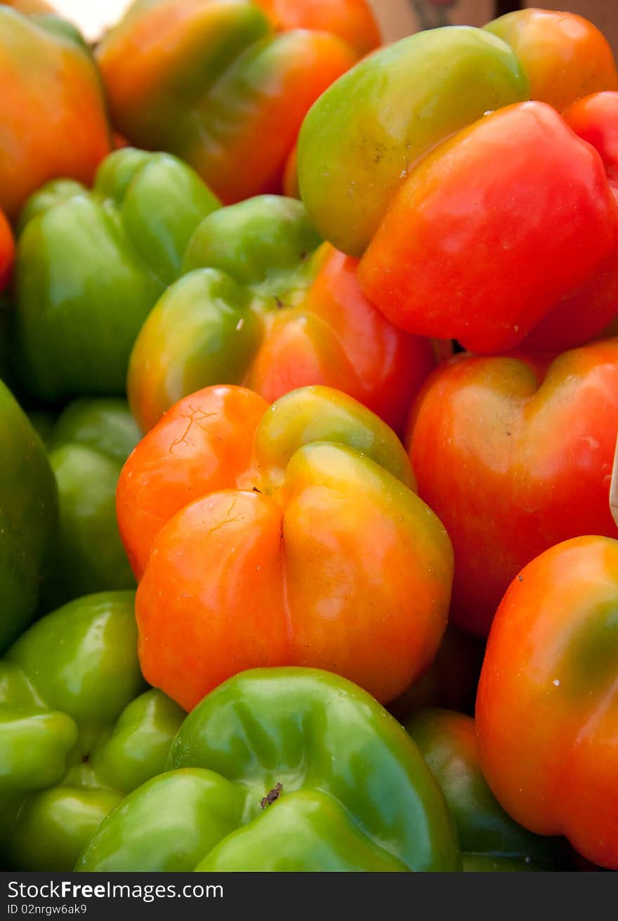 Mutlicolored bell peppers for sale at a farmers' market. Mutlicolored bell peppers for sale at a farmers' market