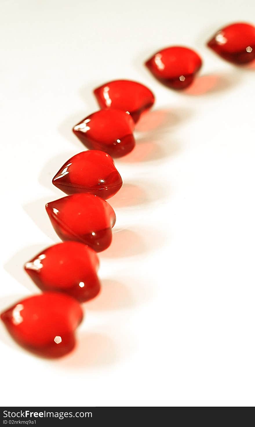 Line of Shiny Red Hearts on White