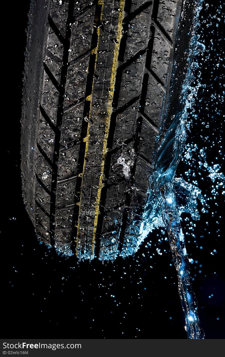 Tire with water drops on it black background