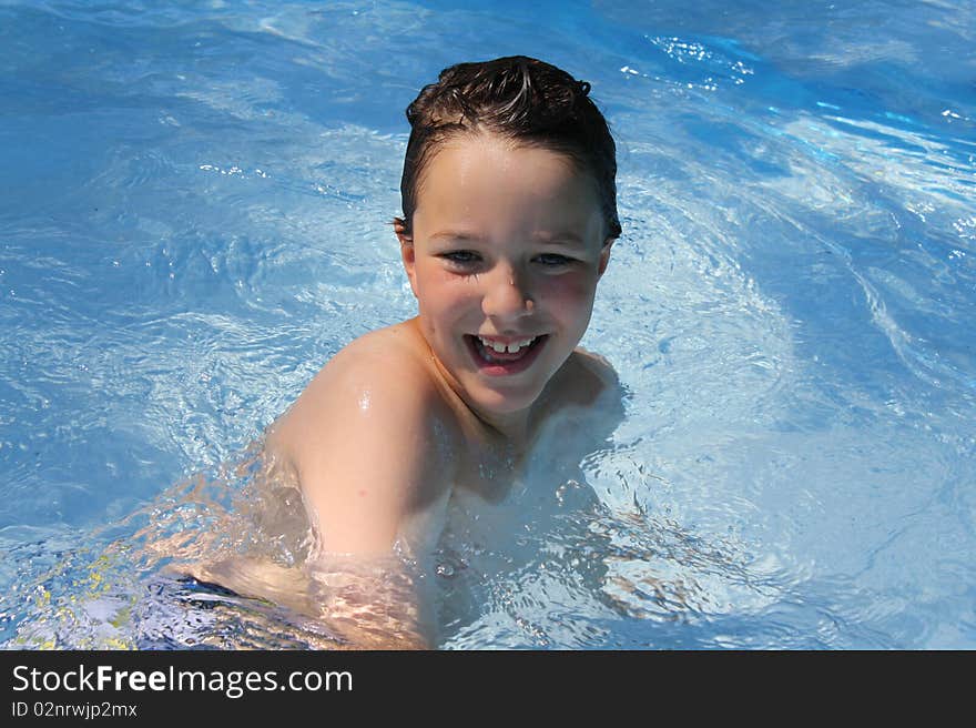 Happy boy playing in a pool. Happy boy playing in a pool.