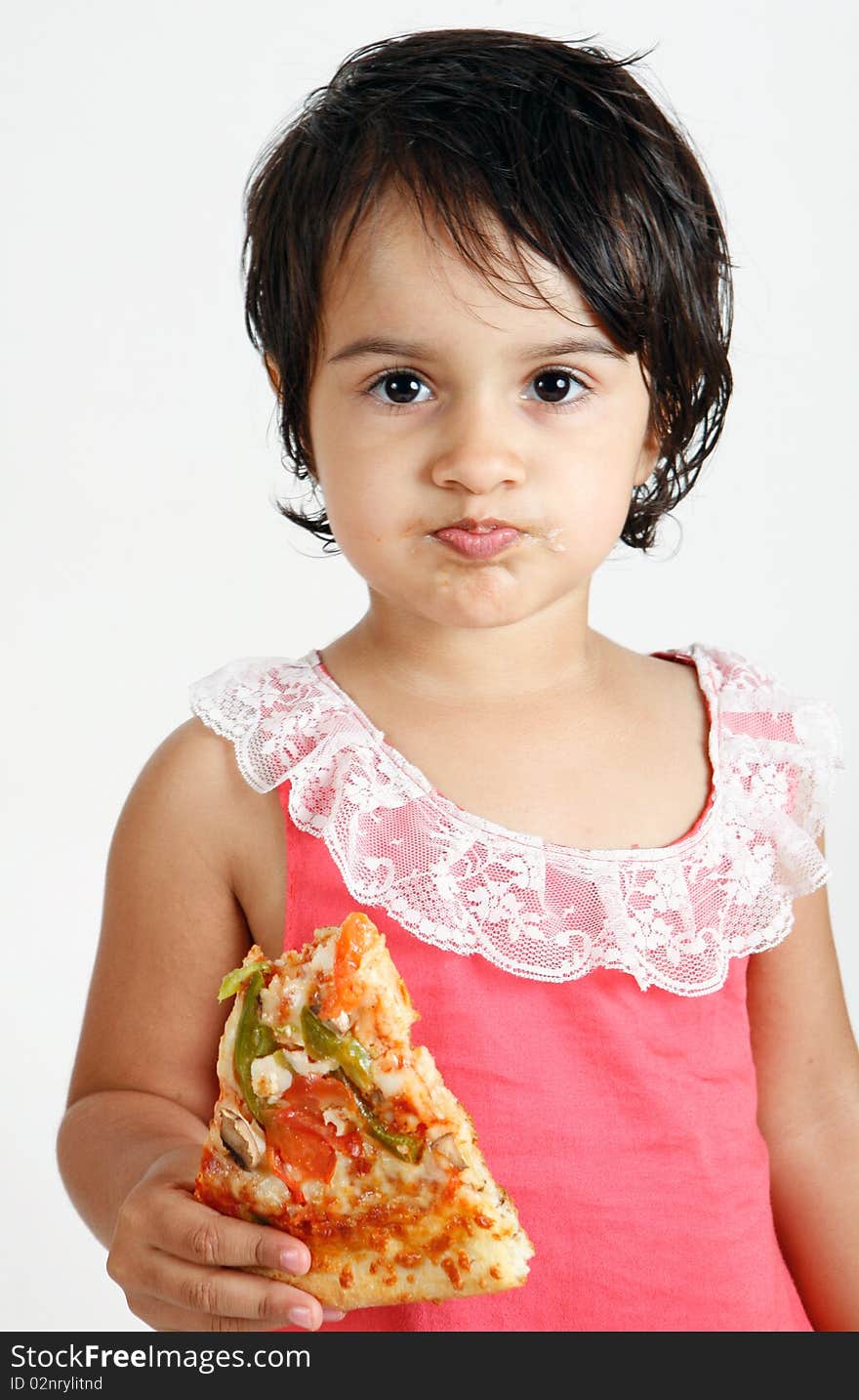 Cute and pretty toddler eating pizza slice