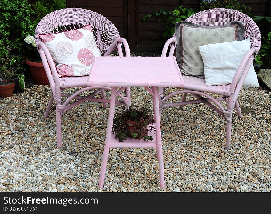 A shingled patio area with chairs for relaxing in the garden. A shingled patio area with chairs for relaxing in the garden