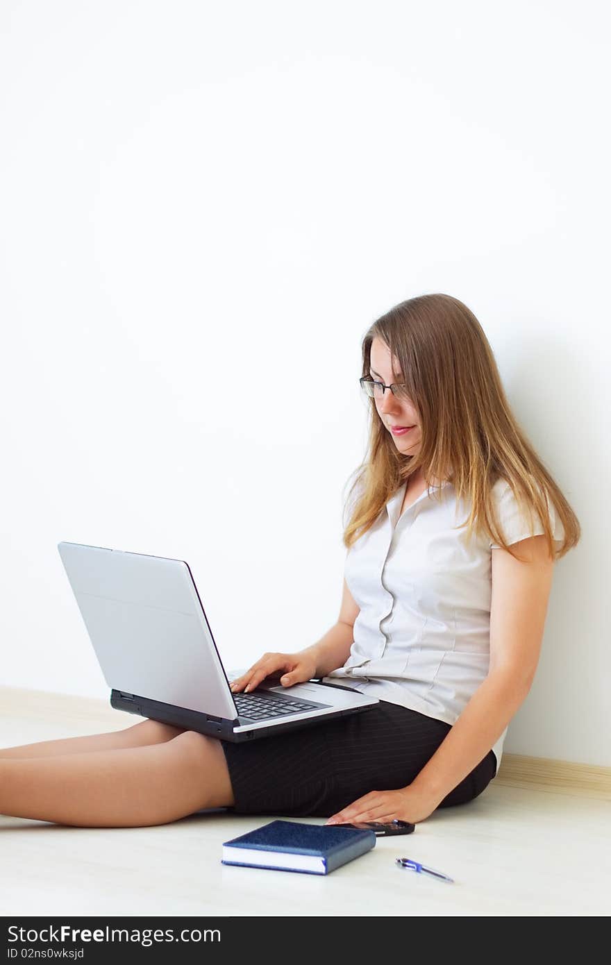 Business woman with laptop on a light background