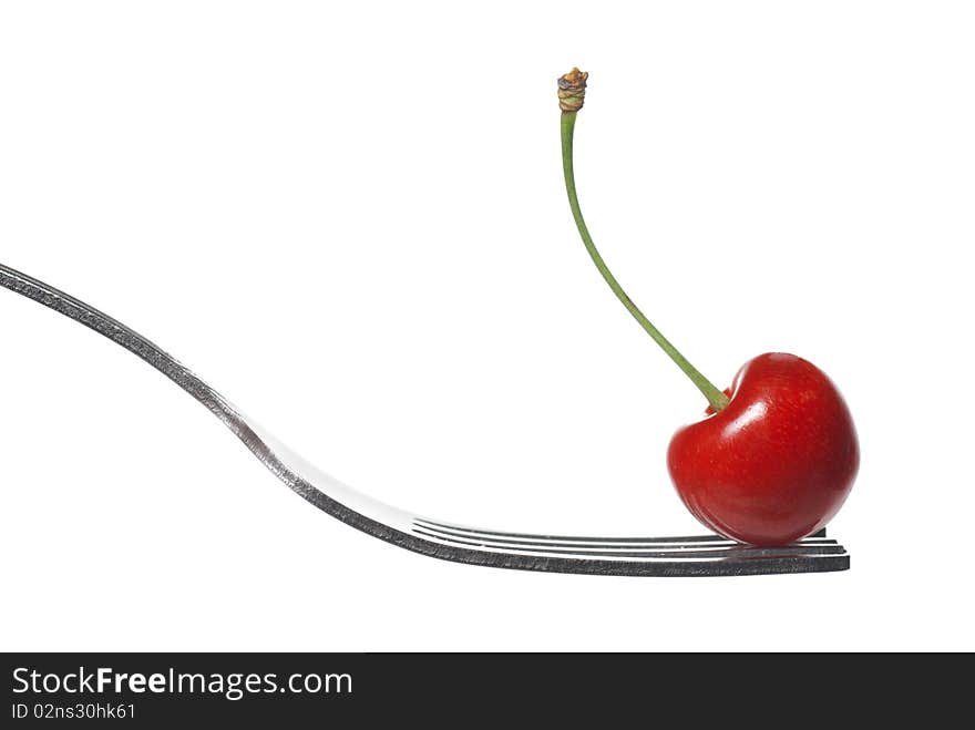 Red cherry on fork isolated on white