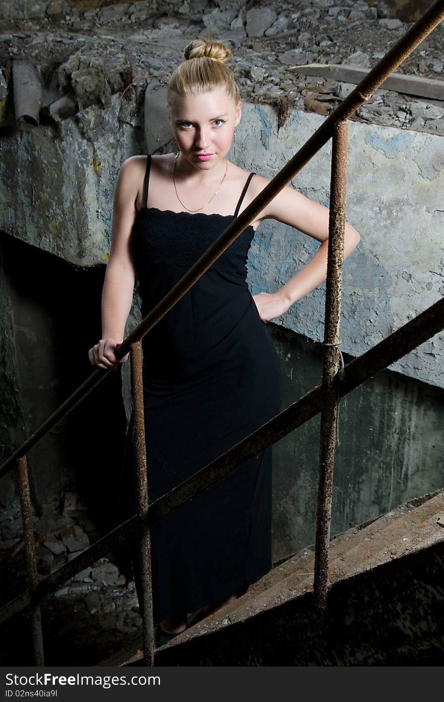 Beautiful chick standing on the grungy stairs. Beautiful chick standing on the grungy stairs