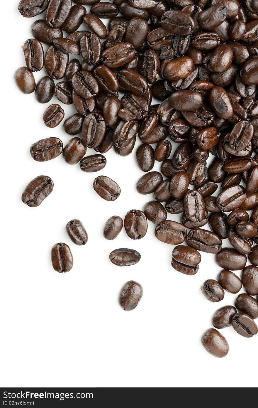 Coffee beans on white background. Heap out from upper right edge for border design element. Coffee beans on white background. Heap out from upper right edge for border design element