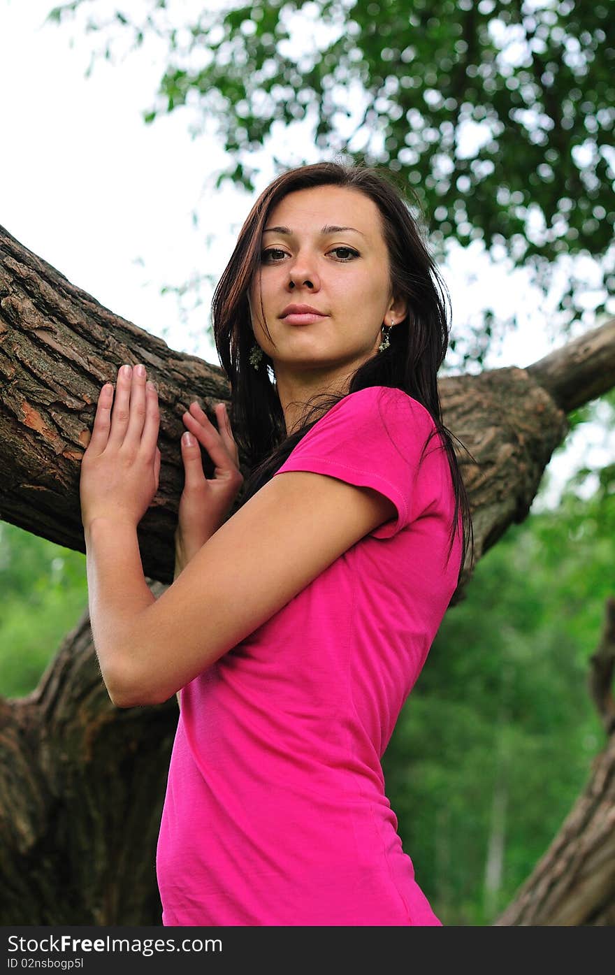 Young woman standing near the big tree. Young woman standing near the big tree