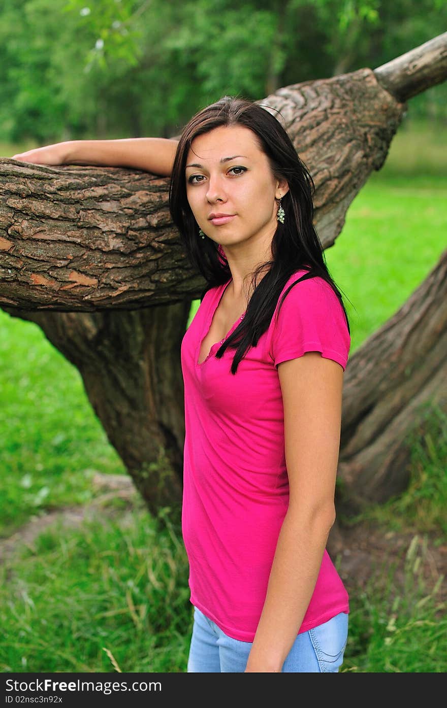 Young woman standing near the big tree. Young woman standing near the big tree