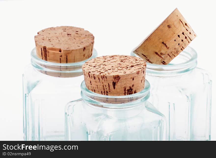 Bottles and corks on white background