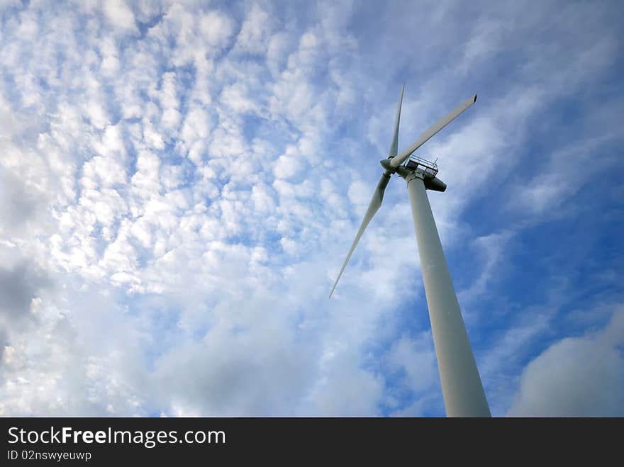 Wind turbines have a sky blue background