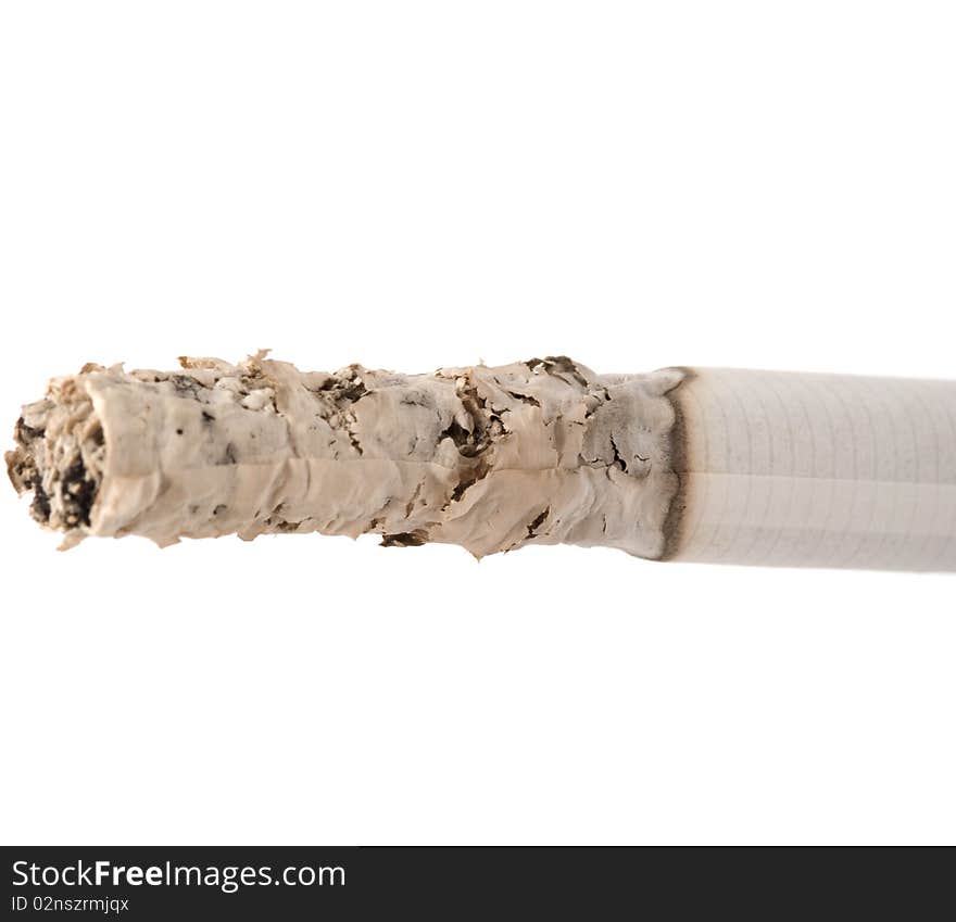 Smoldering cigarette is isolated on a white background. Smoldering cigarette is isolated on a white background.