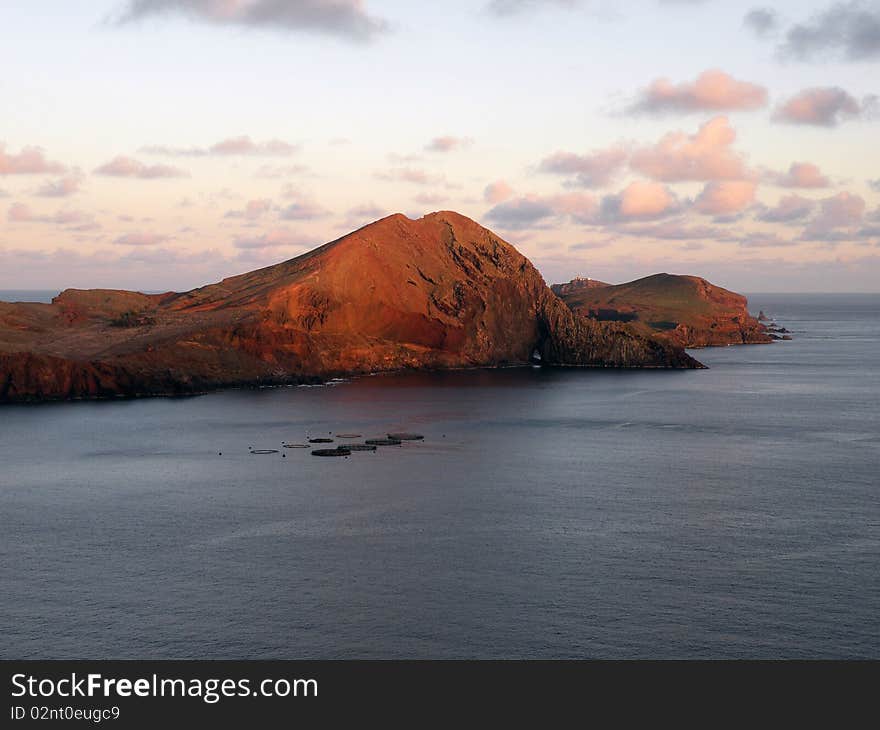 Mountain range in sea with sunset above. Mountain range in sea with sunset above