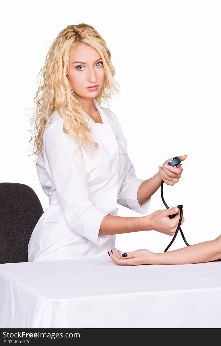 Young female doctor taking blood pressure on white