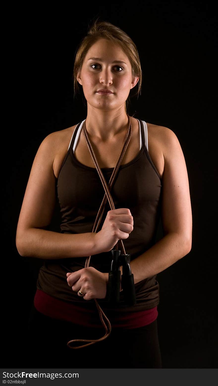 Beautiful fit young woman posing with jump rope. Beautiful fit young woman posing with jump rope