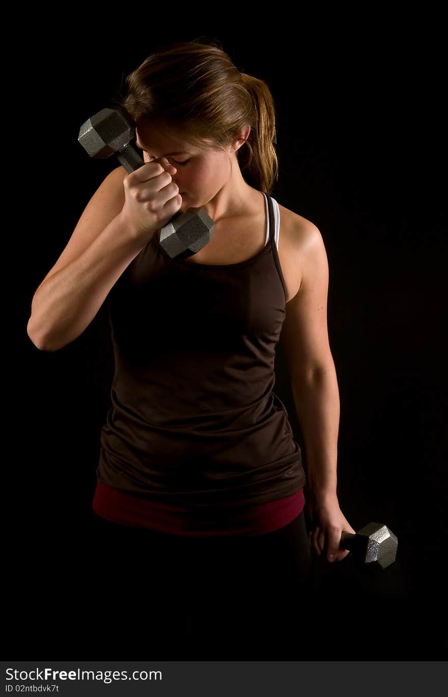 Young Woman Lifiting Weights