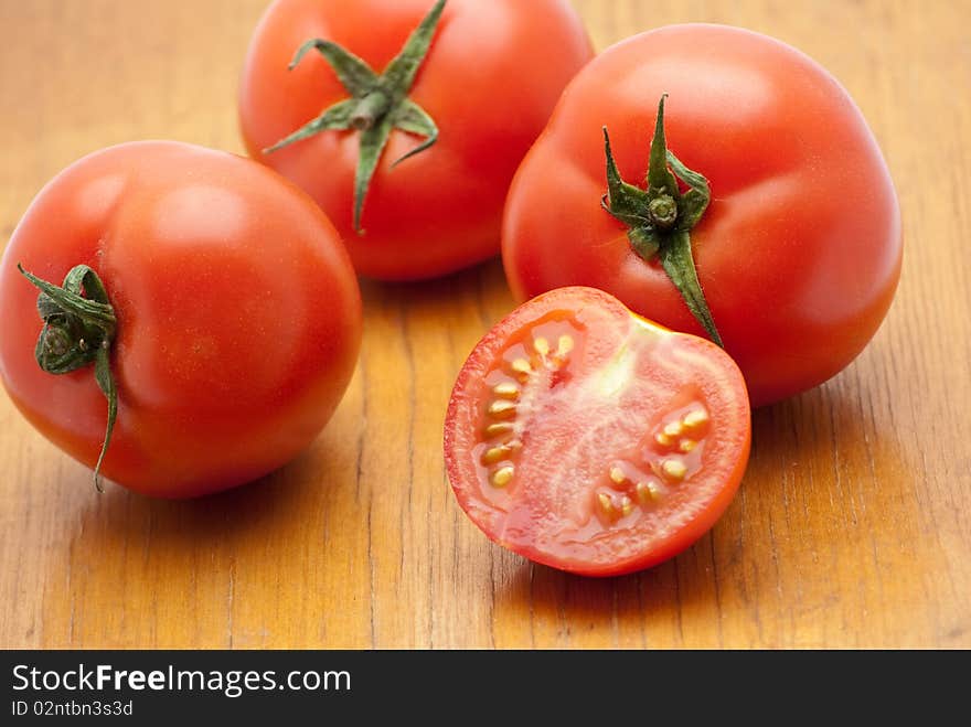 Fresh tomatoes on a wood background.