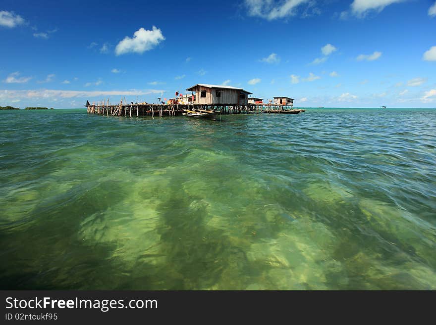 Water Village with deep blue sky, clouds and crystal clear water.