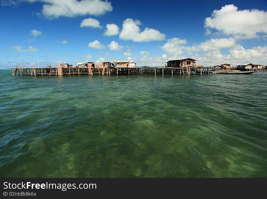 Water Village with deep blue sky, clouds and crystal clear water.