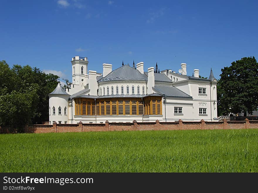 Gothic palace with the garden into a sunny day. Gothic palace with the garden into a sunny day