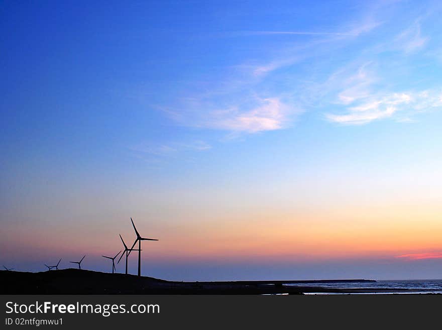 Windmill silhouette with colorful sky at sunset. Windmill silhouette with colorful sky at sunset