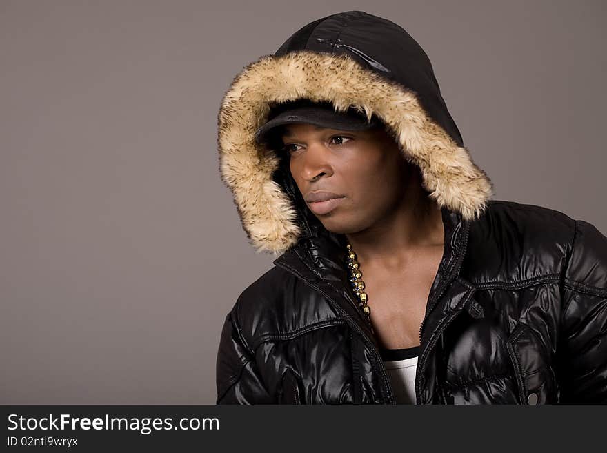 Closeup portrait of young handsome african with head cap on grey background