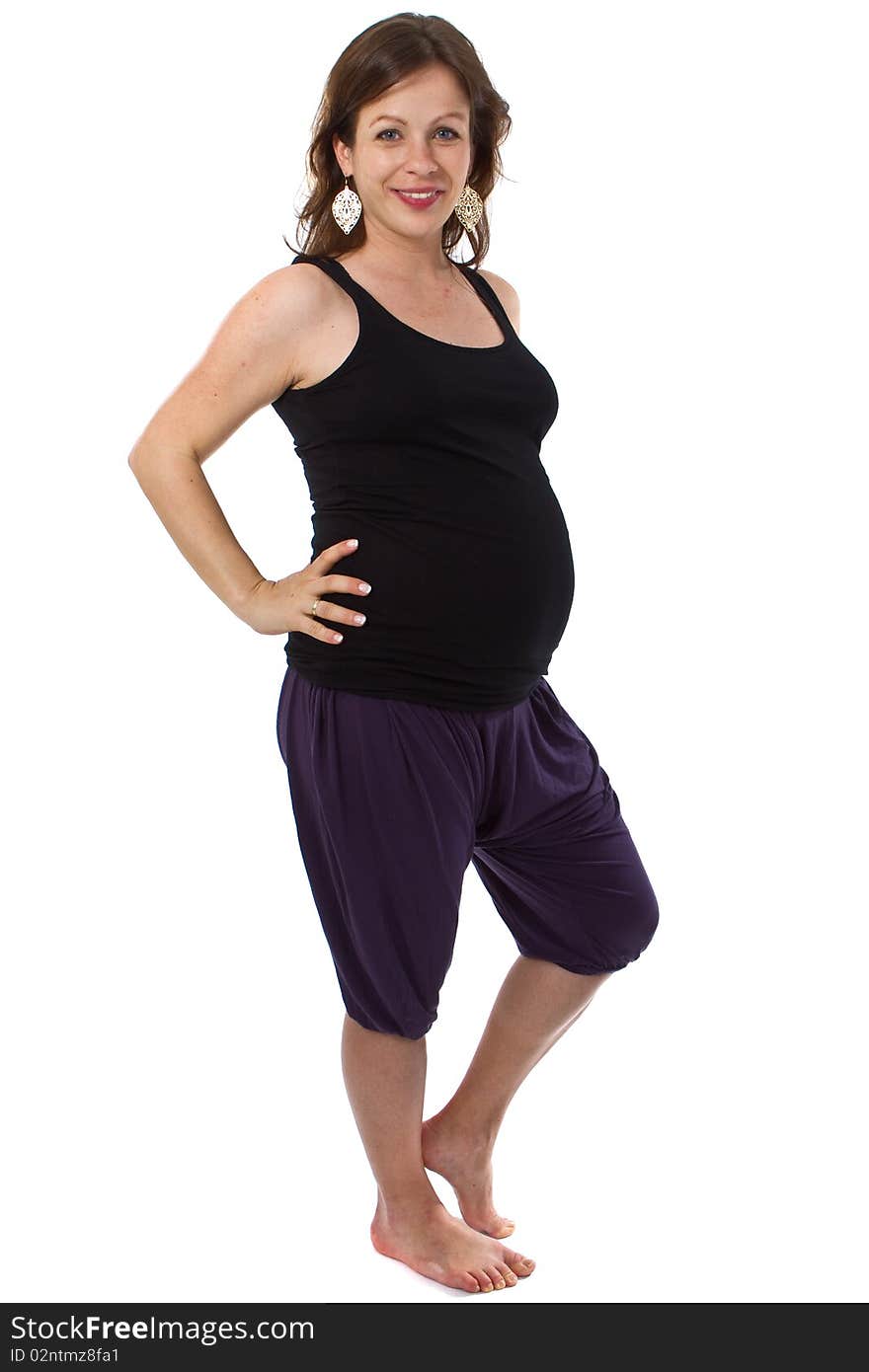 Young pregnant woman in a studio setting isolated over white. Young pregnant woman in a studio setting isolated over white.