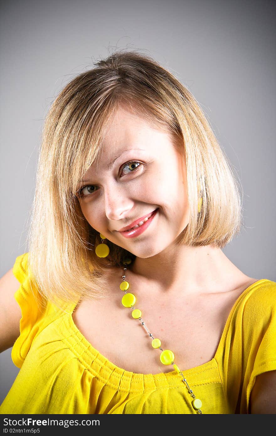 Smiling girl in yellow shirt