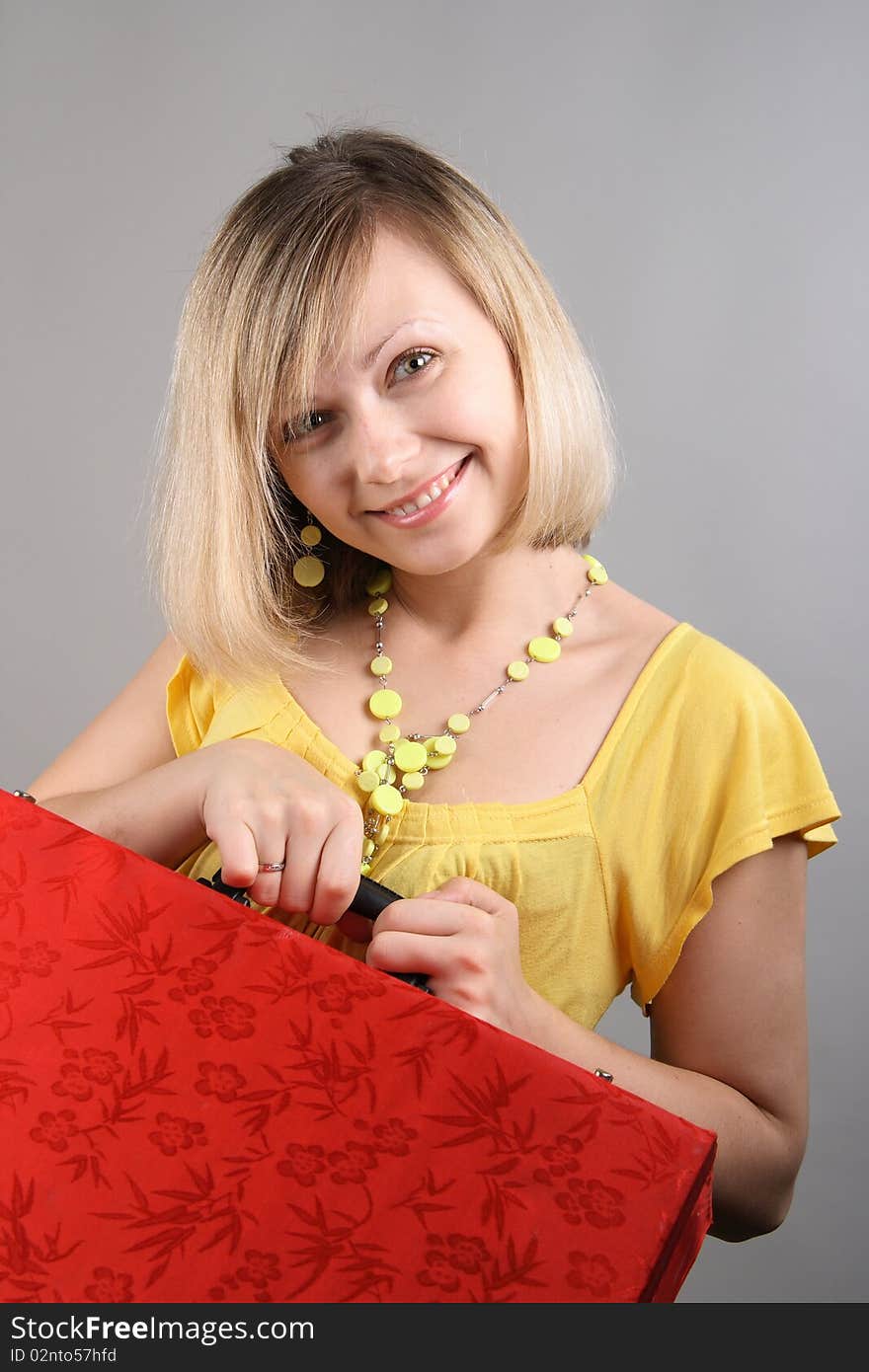 Smiling Girl In Yellow Shirt With Red Bag