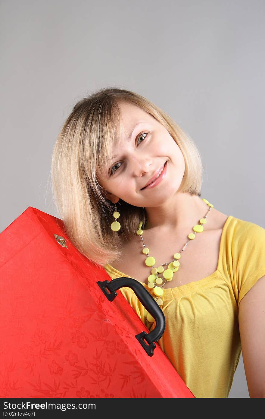 Smiling Girl In Yellow Shirt With Red Bag