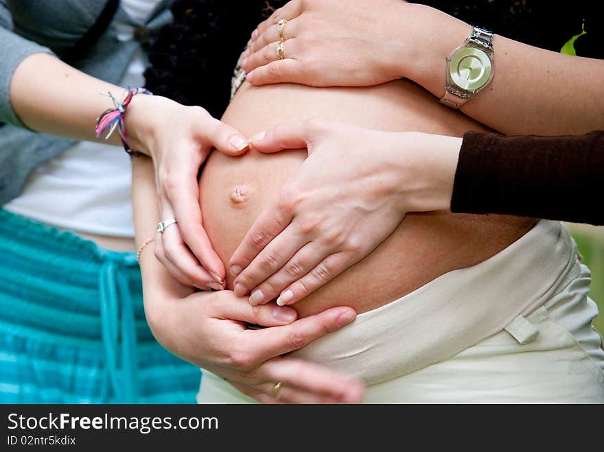 Heart shape made from hands on pregnant woman stomach. Heart shape made from hands on pregnant woman stomach