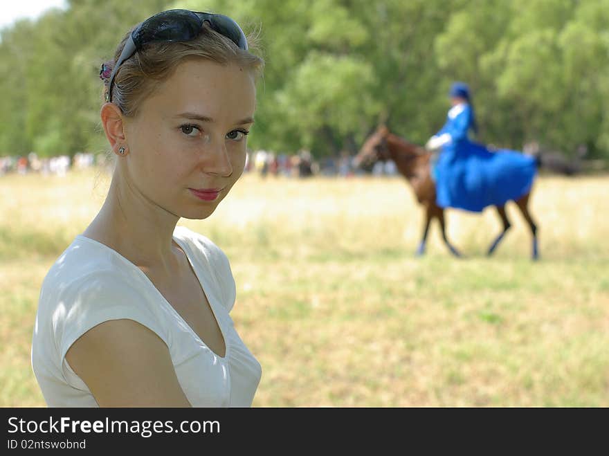 Girl and a horsewoman in the background