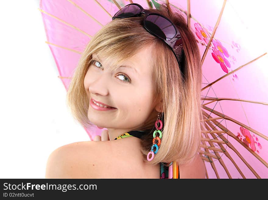 Portrait of girl with pink umbrella in studio over grey