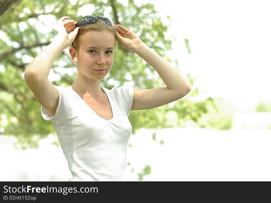 Female in a white t-shirt near the lake