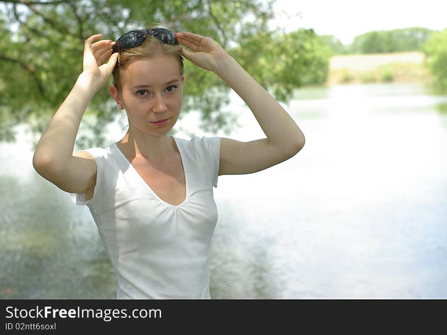 Girl in a white t-shirt near the lake. Girl in a white t-shirt near the lake