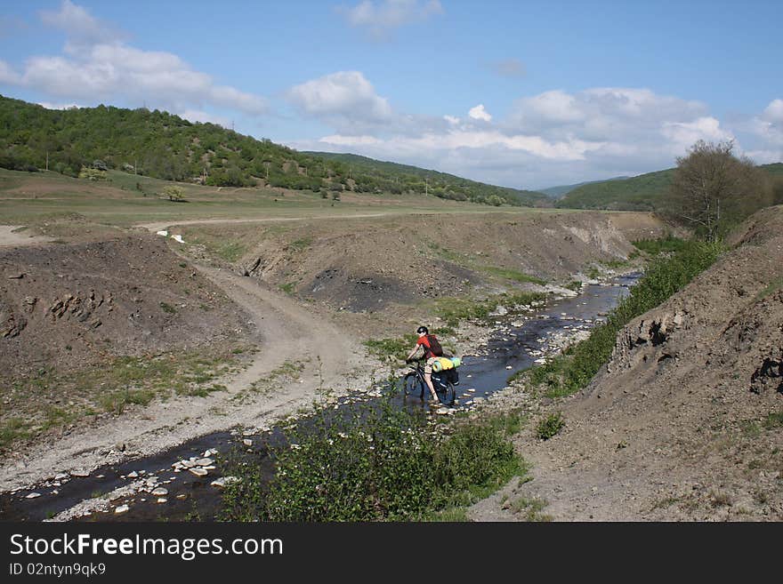 Mountain Biker Crossing River